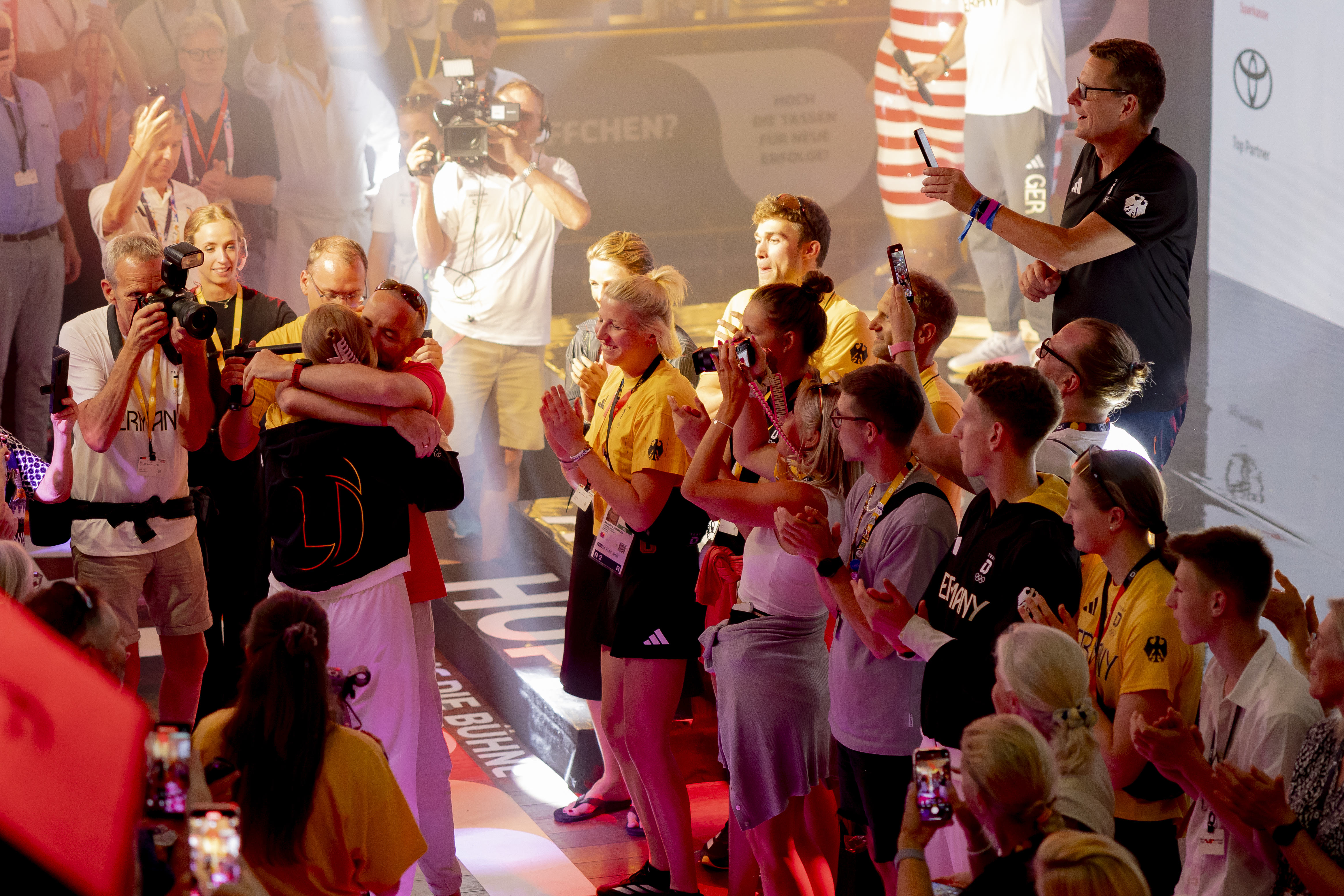 Isabel Gose embracing her father during the medal celebration at the German House