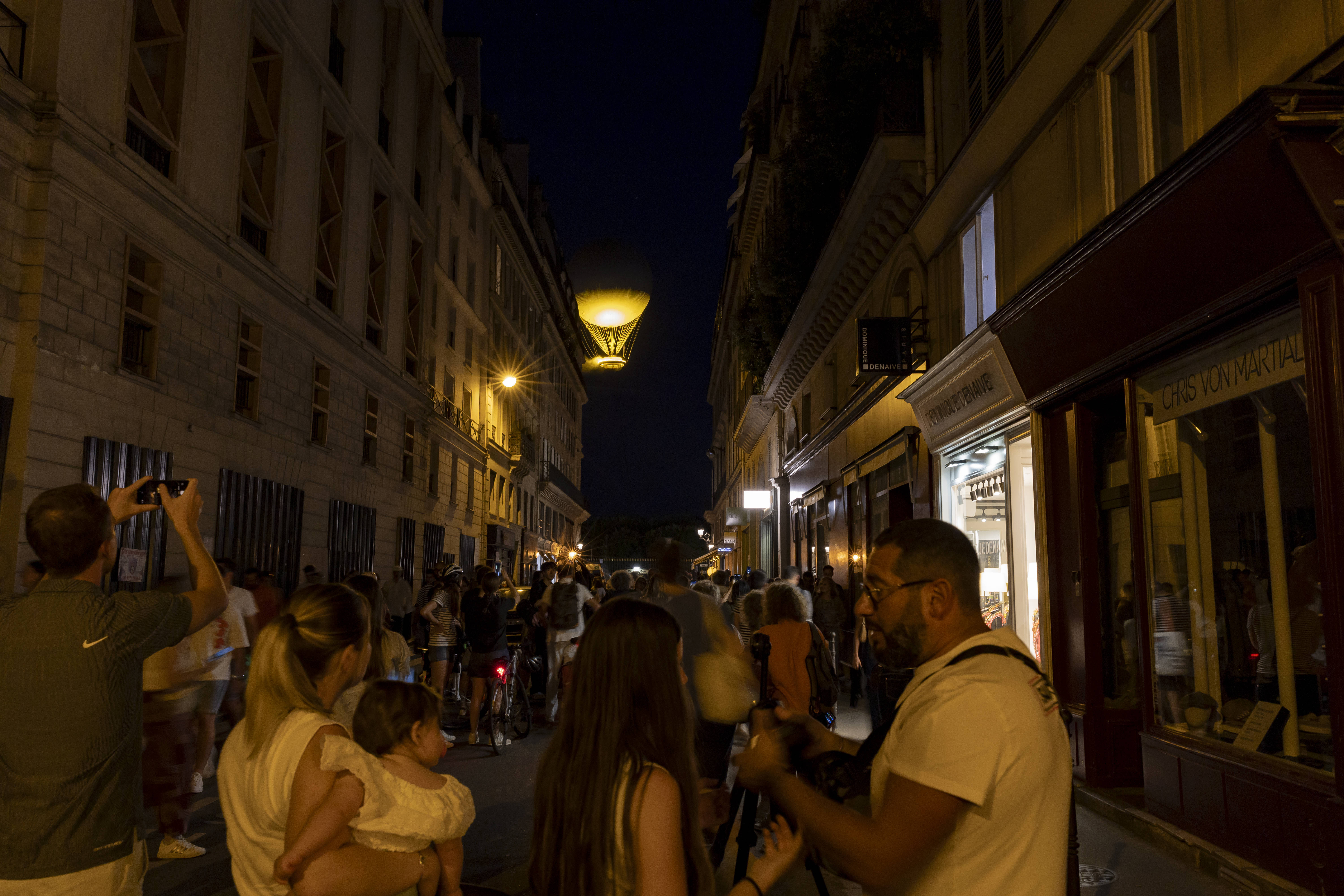 Crowds gathering around the Olympic Flame in Paris