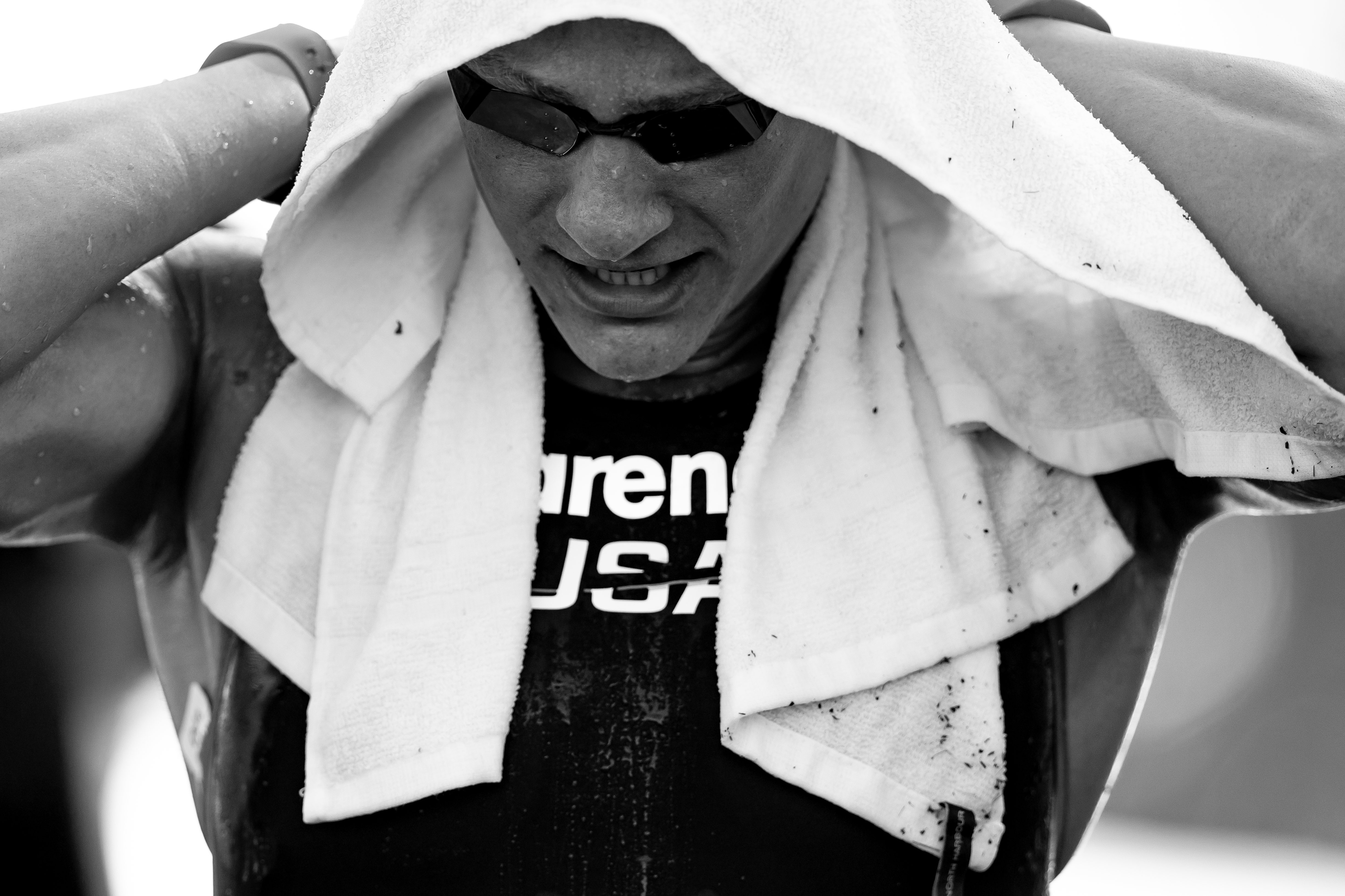 American open water athlete under a towel before or after competition in Singapore