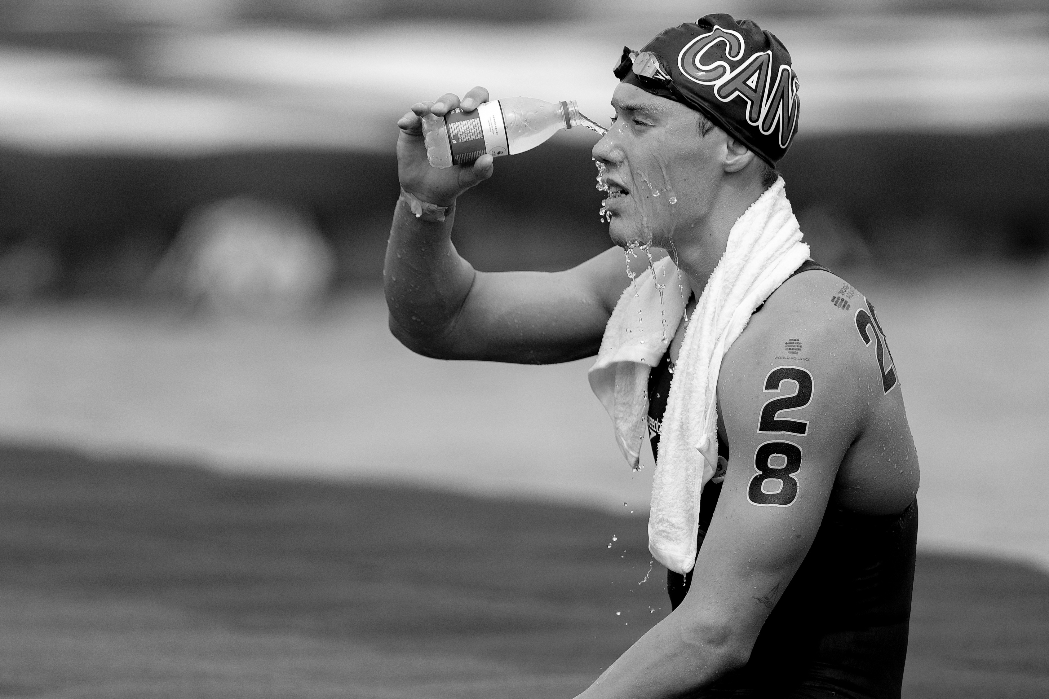 Canadian athlete cooling down with water after competition in Singapore