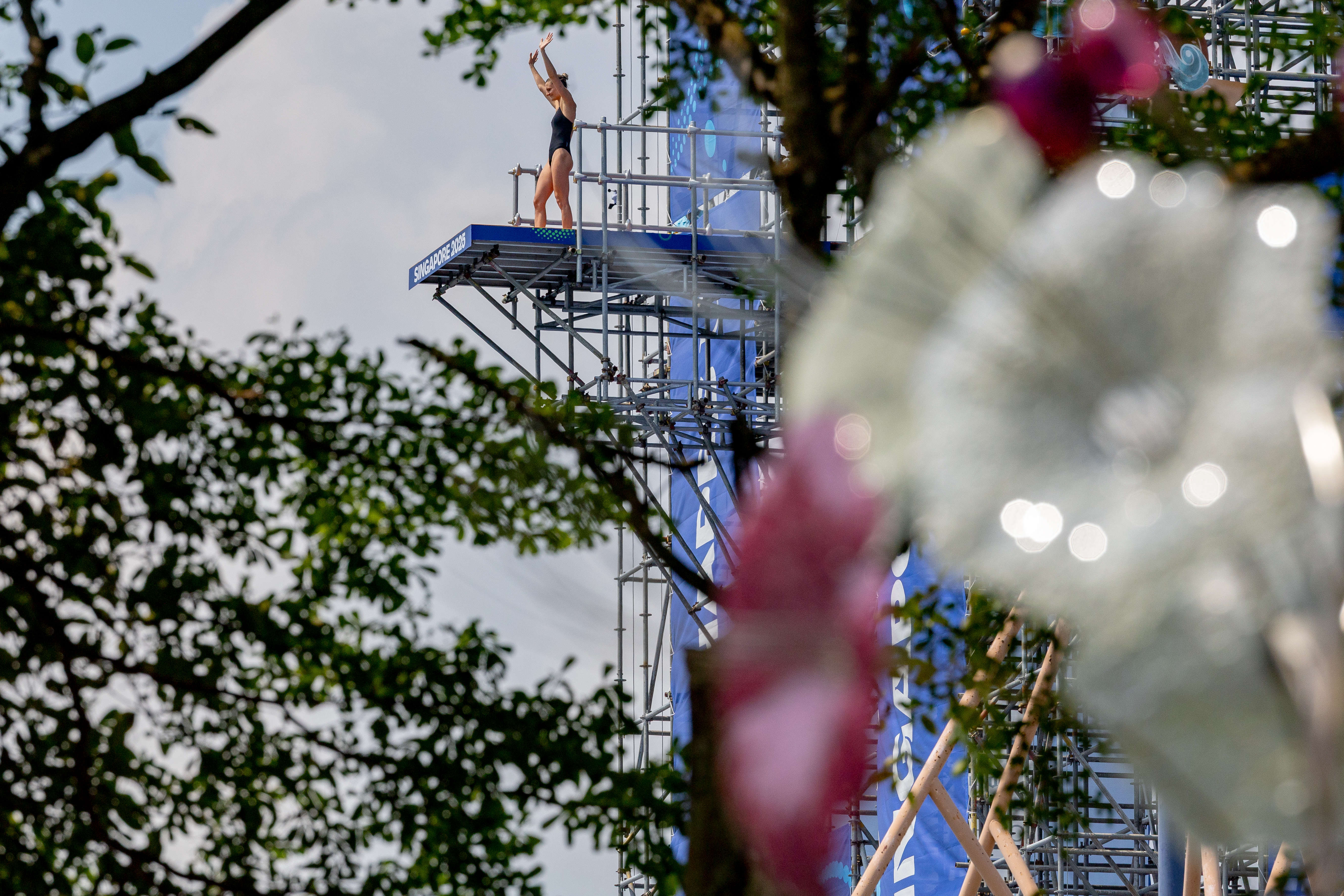 German high diver waving from the platform in Singapore