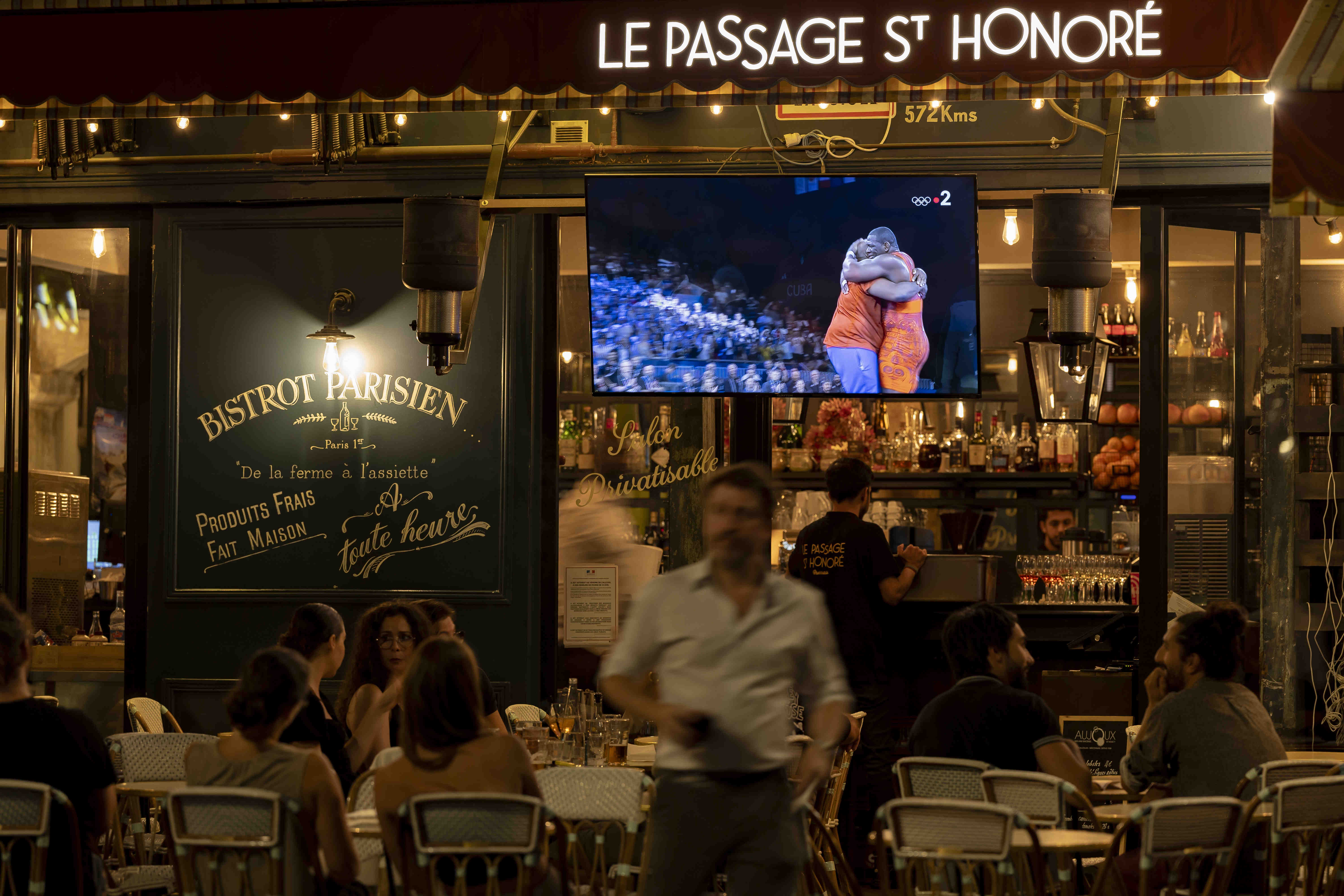 People watching the Olympic Games in a Paris restaurant