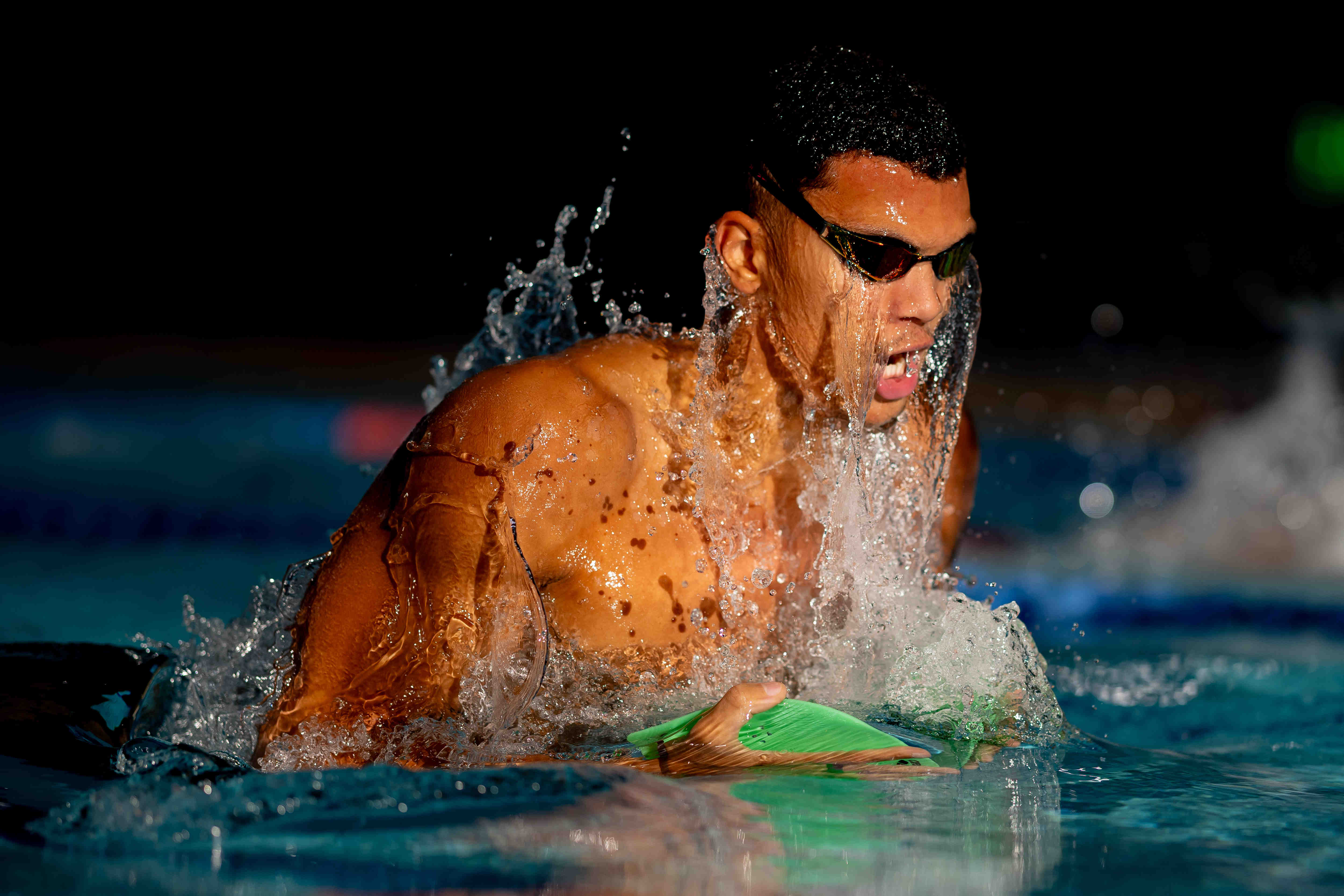 Training silhouettes and sunlight at the International School pool in Singapore