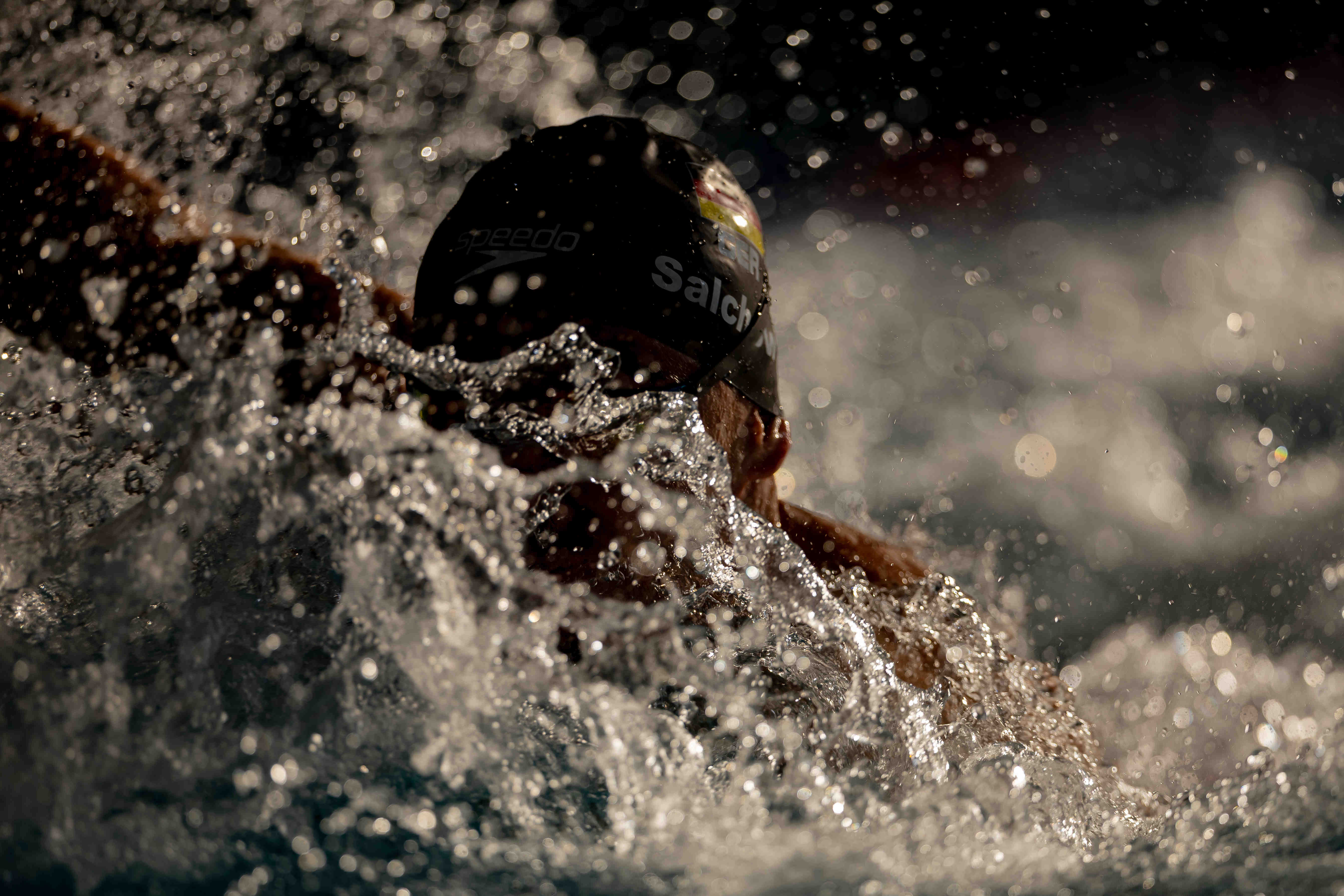 Training silhouettes and evening sunlight at the International School pool in Singapore