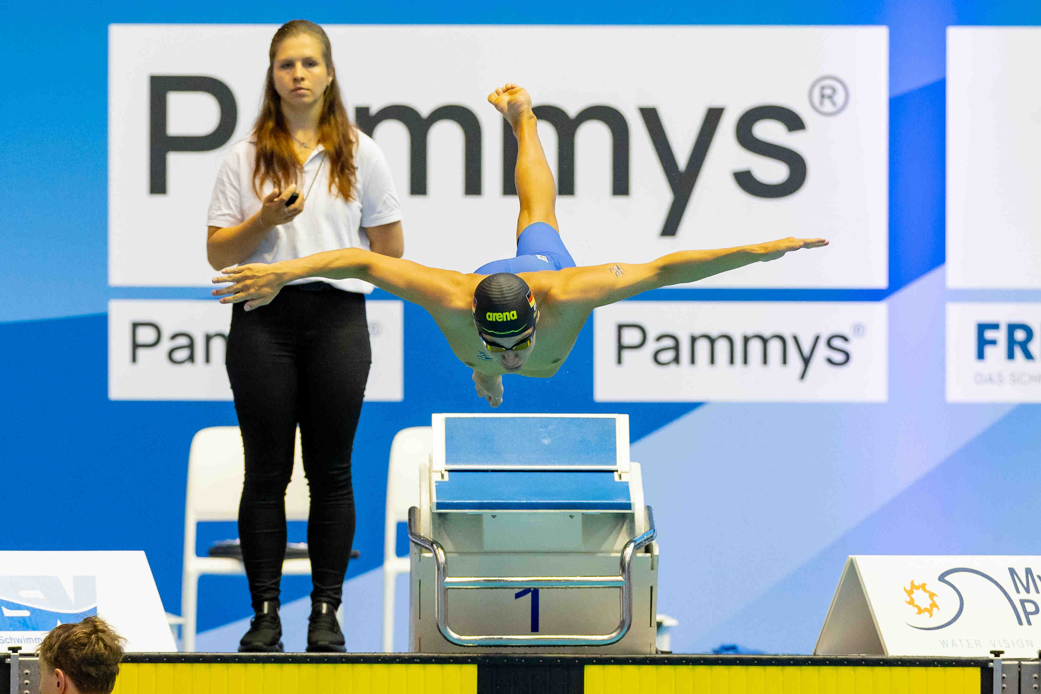 DJM swimmer flying through the start
